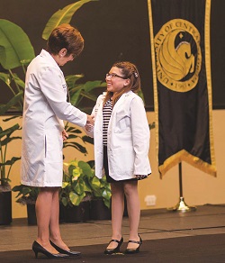 Jessica Fernandez Robe accepting diploma from University of Central Florida (UCF) College of Medicine 