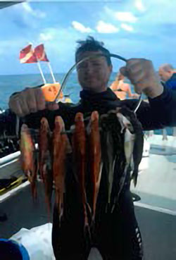 Paul Voegerl dive instructor showing off the fish he caught.