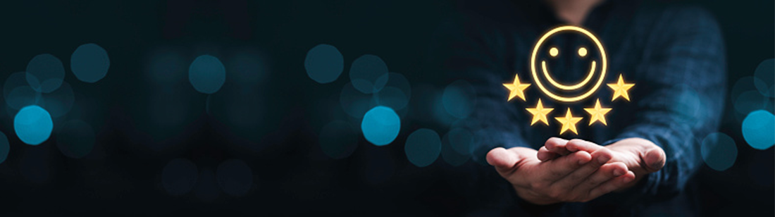 Hands holding a smiling face with five stars.